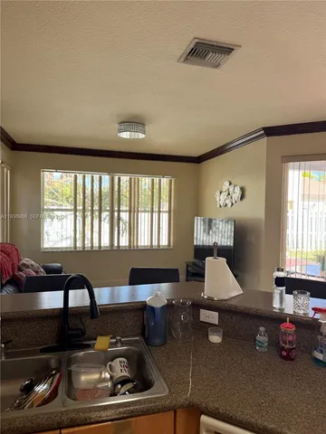 a living room with furniture and floor to ceiling window
