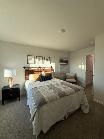 a bedroom with a bed and a lamp