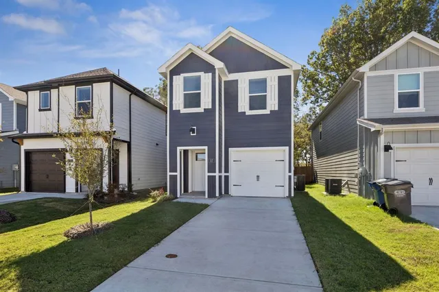 a front view of a house with a garden and plants