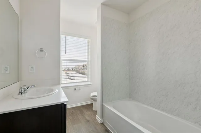 a white bath tub sitting next to a white sink