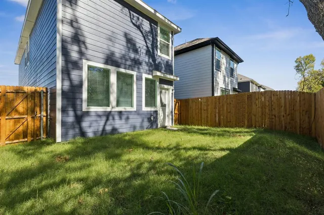 a view of backyard of house with green space