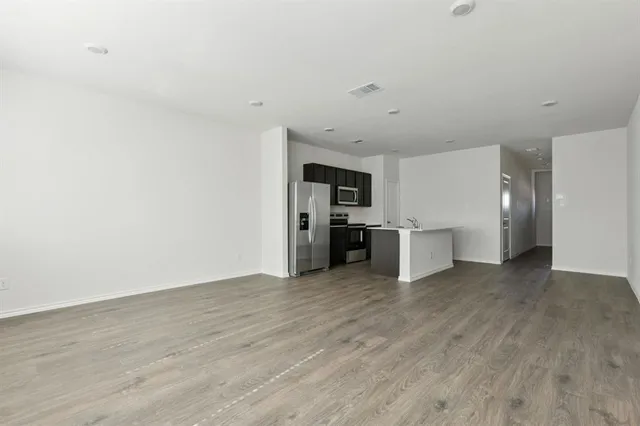 a view of a kitchen with a sink and a refrigerator