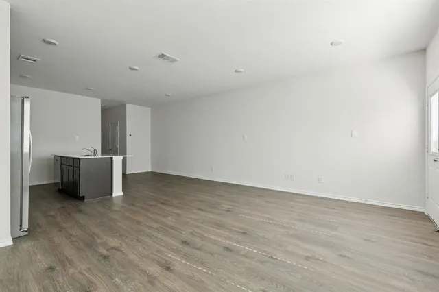 a view of a room with wooden floor