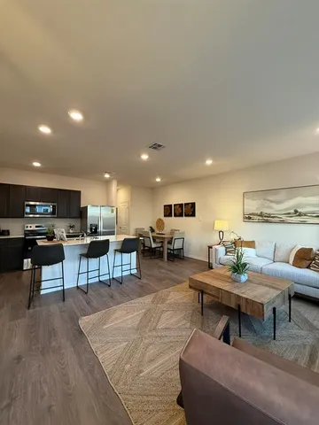 a living room with furniture and kitchen view