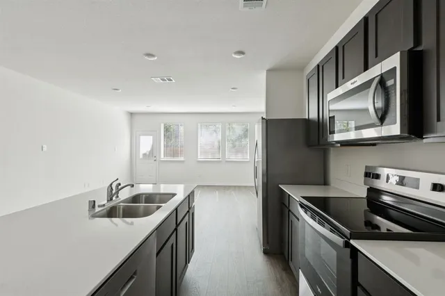 a kitchen that has a sink and a stove