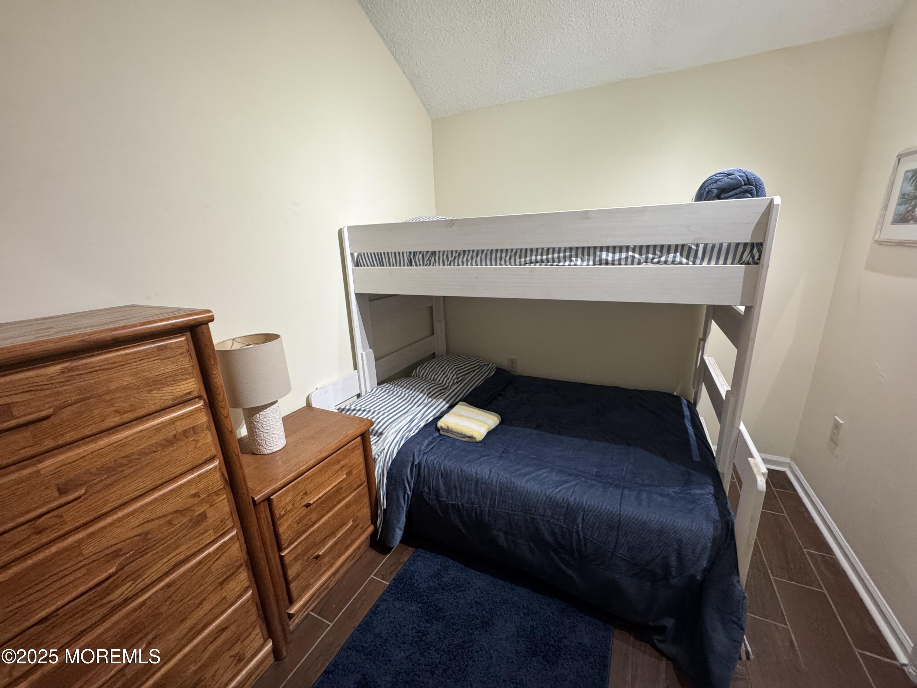 124 Lincoln Avenue, Unit 4 Seaside Heights, NJ 08751 - Photo 9 of 14 a bedroom with a bunk bed and a chair