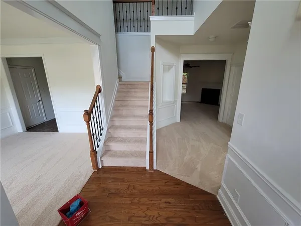 a view of entryway and hall with wooden floor