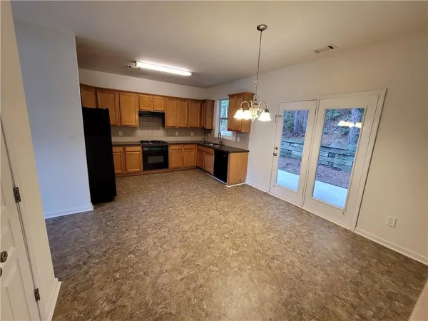 a open kitchen with refrigerator and cabinets