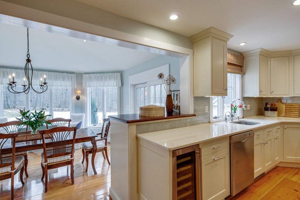 42 Oak Hill Road Harvard, MA 01451 - Photo 16 of 30 a kitchen with a table chairs refrigerator and microwave