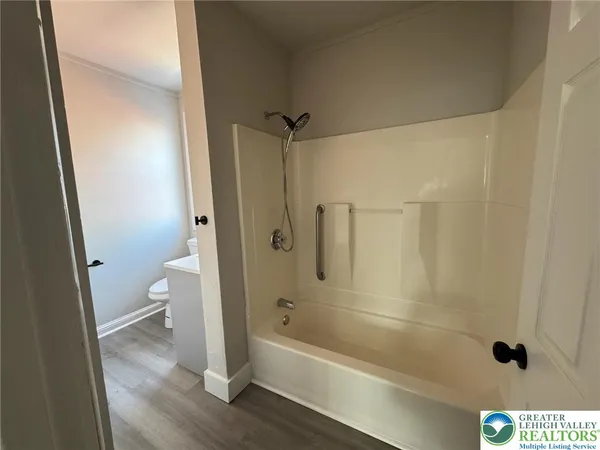 a bathroom with a tub and a shower