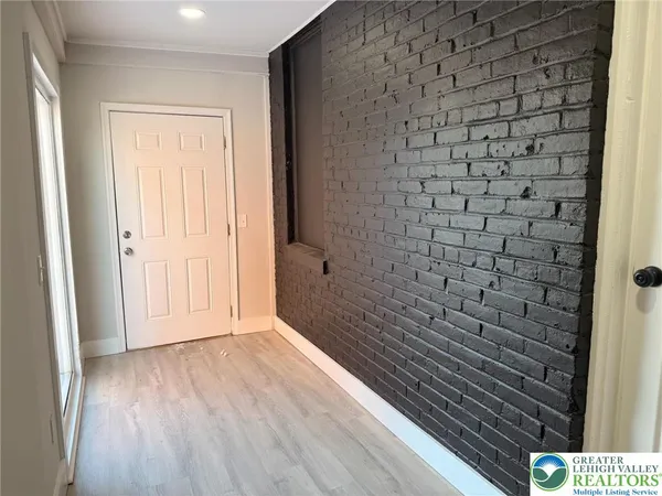 a bathroom with a wooden floor and a shower