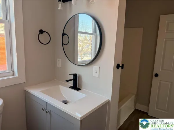 a bathroom with a sink and a mirror