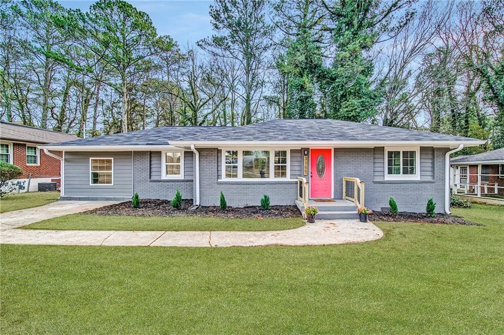a view of a house with a backyard