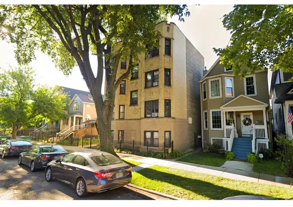 a car parked in front of a brick house