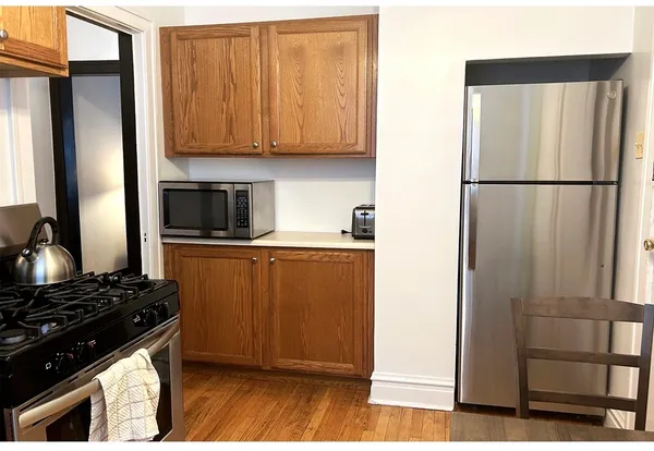 a kitchen with stainless steel appliances granite countertop a refrigerator and a stove