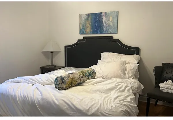 a bedroom with a bed and window