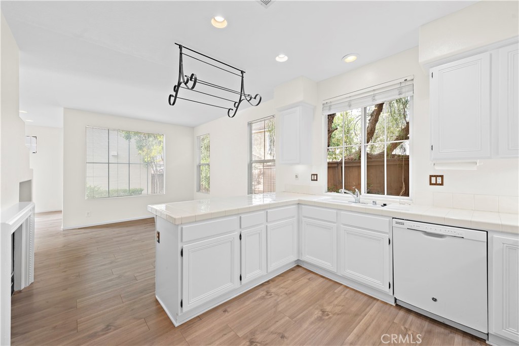 68 Kyle Court Ladera Ranch, CA 92694 - Photo 12 of 25 a kitchen with white cabinets and window