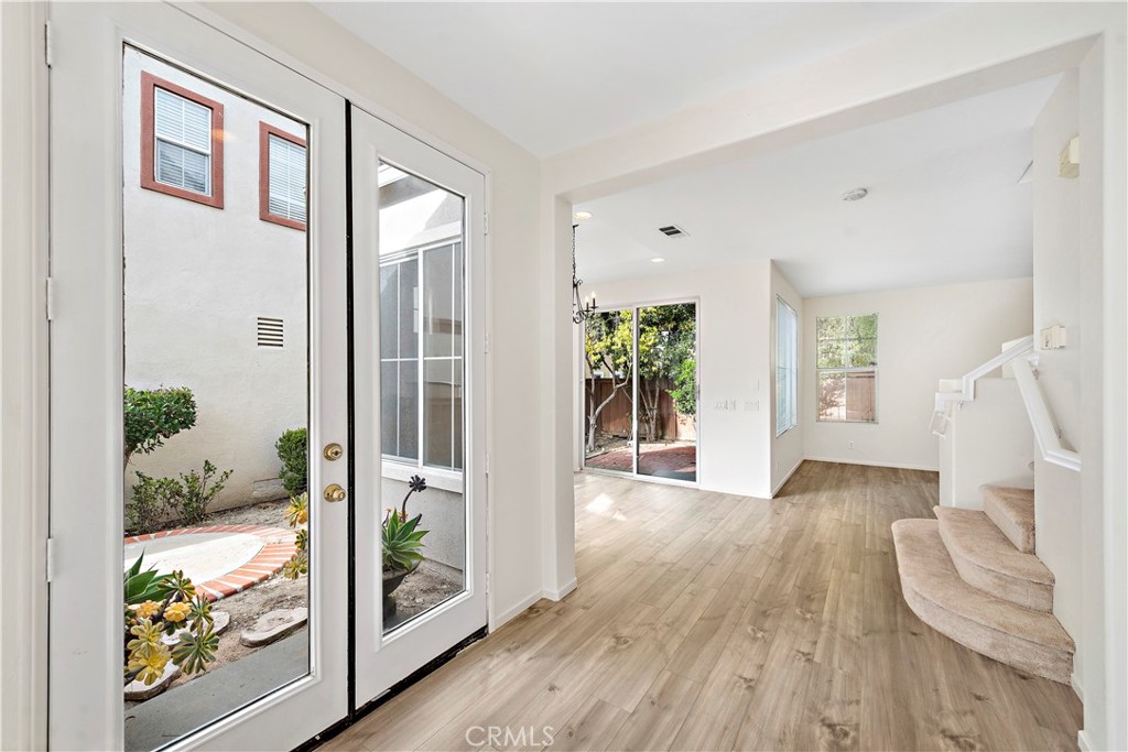 68 Kyle Court Ladera Ranch, CA 92694 - Photo 5 of 25 a view of an entryway with wooden floor and windows