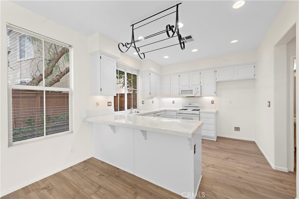 68 Kyle Court Ladera Ranch, CA 92694 - Photo 10 of 25 a kitchen with a stove a refrigerator and a sink