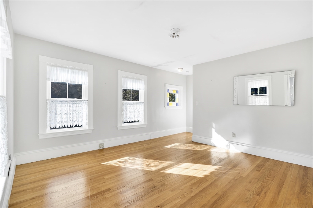 16 County Street Foxboro, MA 02035 - Photo 12 of 33 a view of an empty room with wooden floor and a window