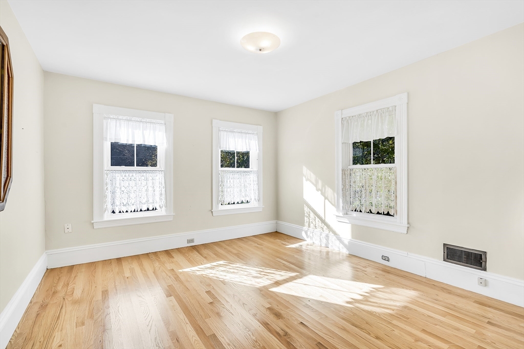 16 County Street Foxboro, MA 02035 - Photo 13 of 33 a view of an empty room with wooden floor and a window