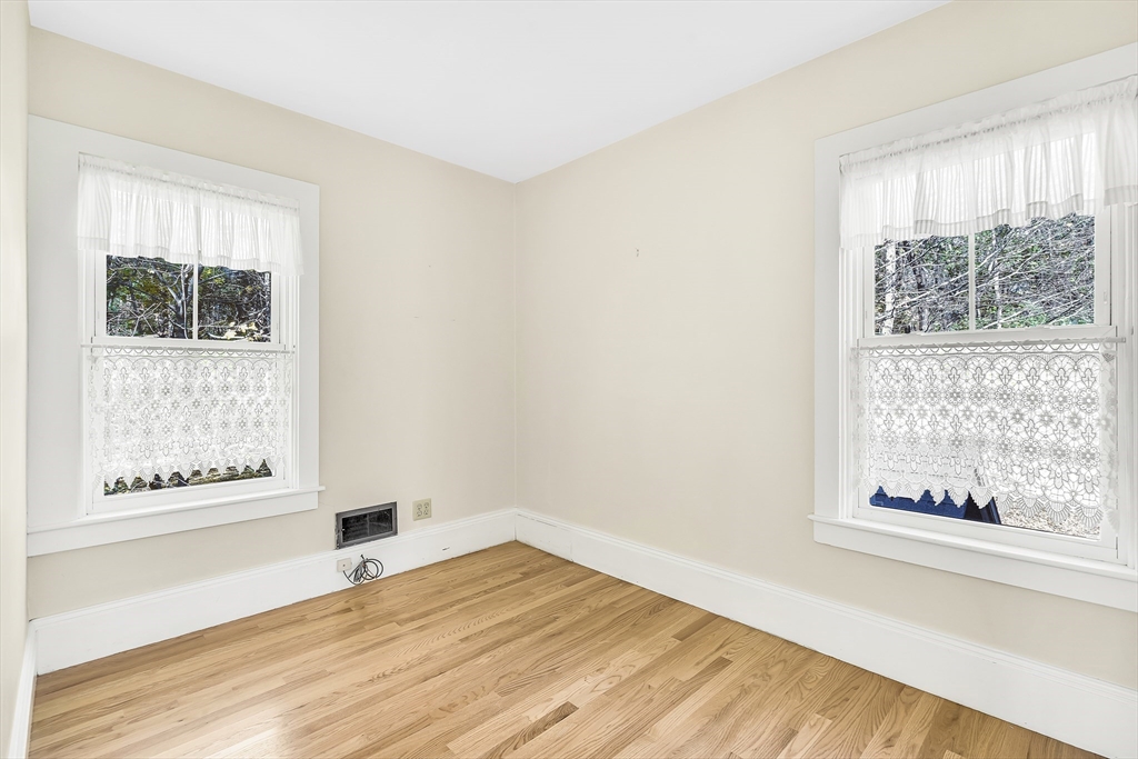 16 County Street Foxboro, MA 02035 - Photo 15 of 33 a view of an empty room with wooden floor and a window