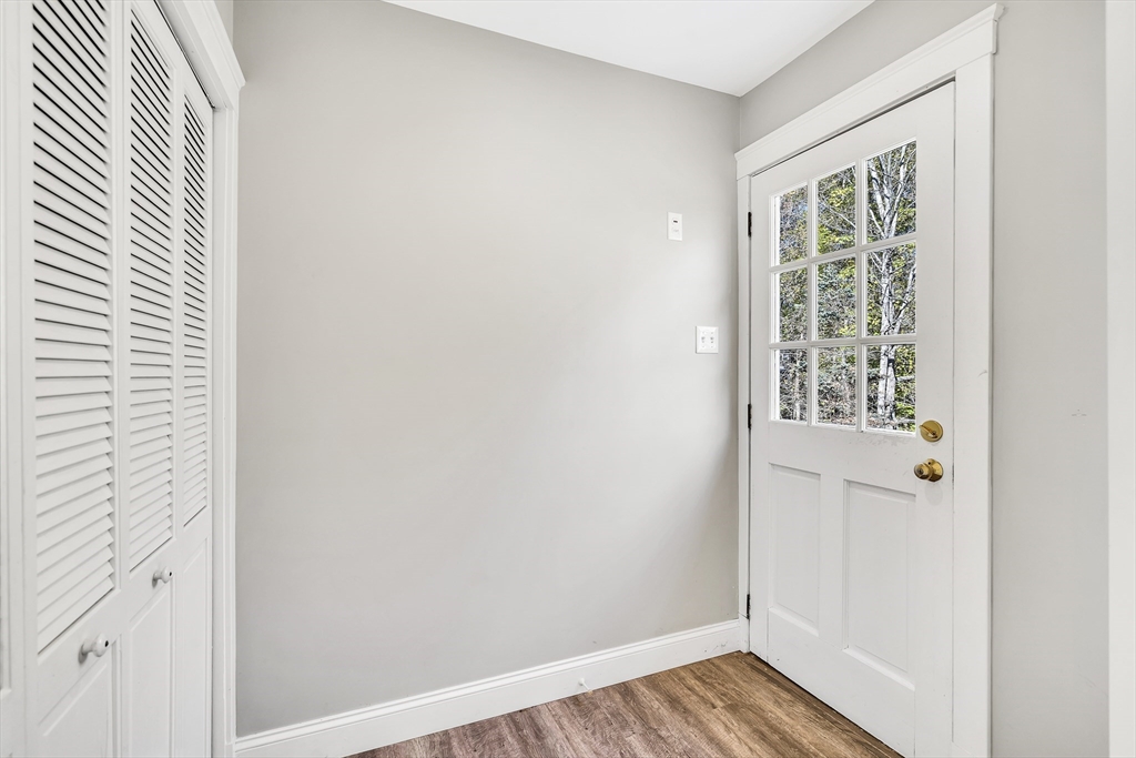 16 County Street Foxboro, MA 02035 - Photo 4 of 33 a view of an empty room with wooden floor and a window