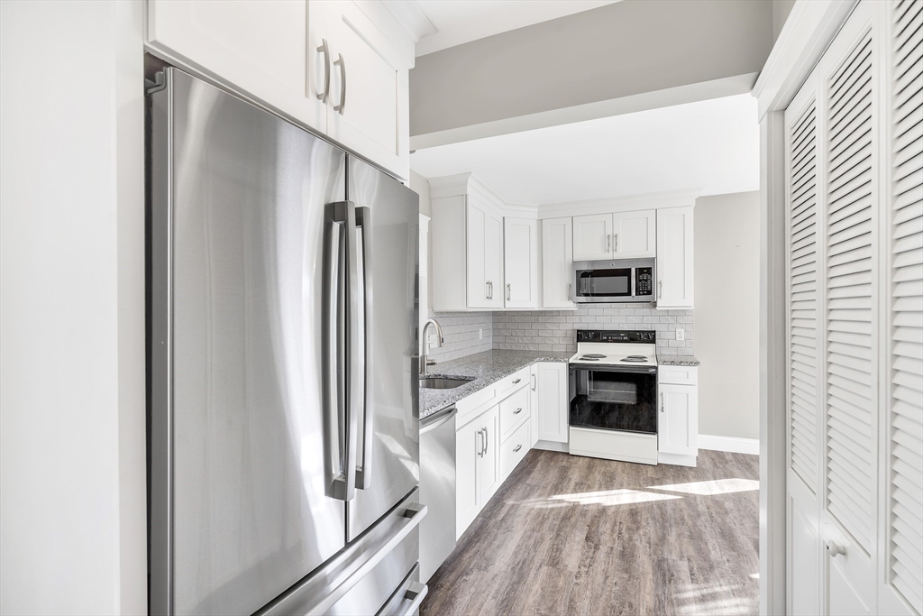 16 County Street Foxboro, MA 02035 - Photo 5 of 33 a kitchen with white cabinets and stainless steel appliances