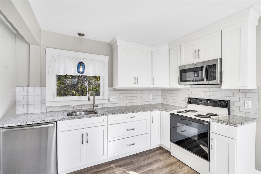 16 County Street Foxboro, MA 02035 - Photo 8 of 33 a kitchen with white cabinets white stainless steel appliances and sink