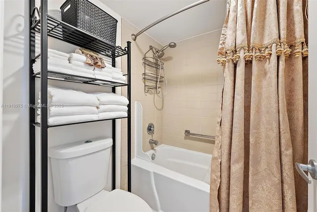 a bathroom with a shower a toilet and a sink