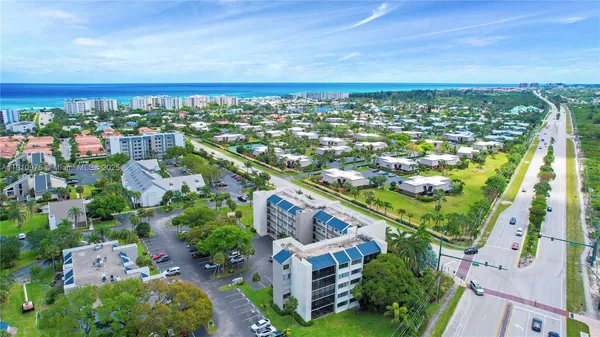 an aerial view of residential building and lake