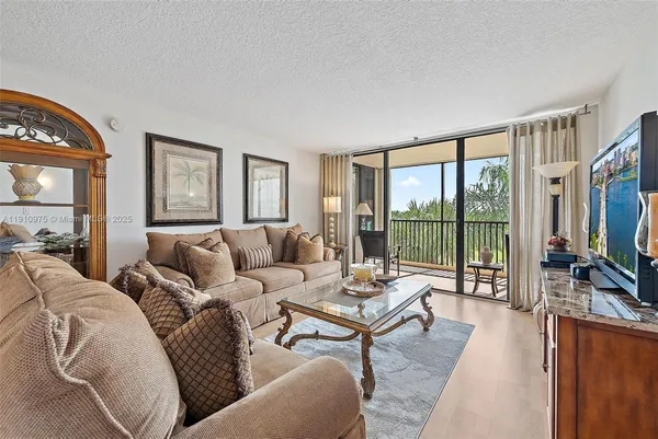 a living room with furniture large windows and a flat screen tv