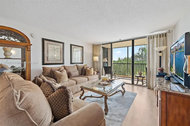 a living room with furniture large windows and a flat screen tv