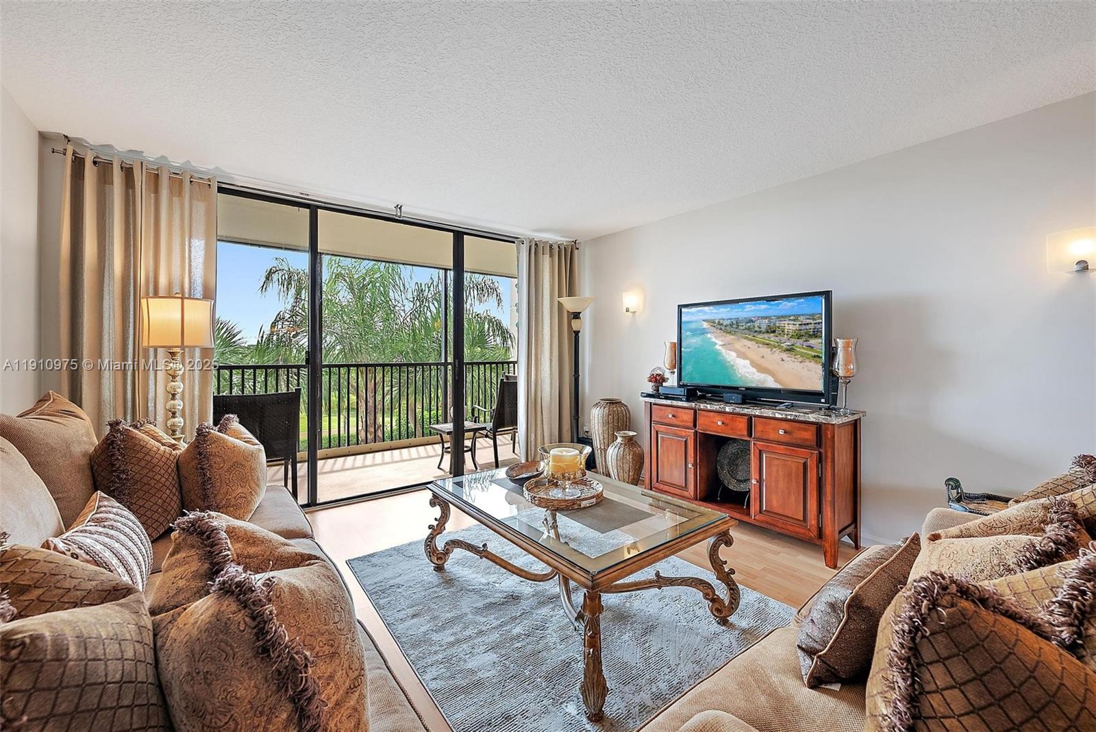 1605 Highway 1, Unit M1405 Jupiter, FL 33477 - Photo 7 of 22 a living room with furniture a large window and a flat screen tv