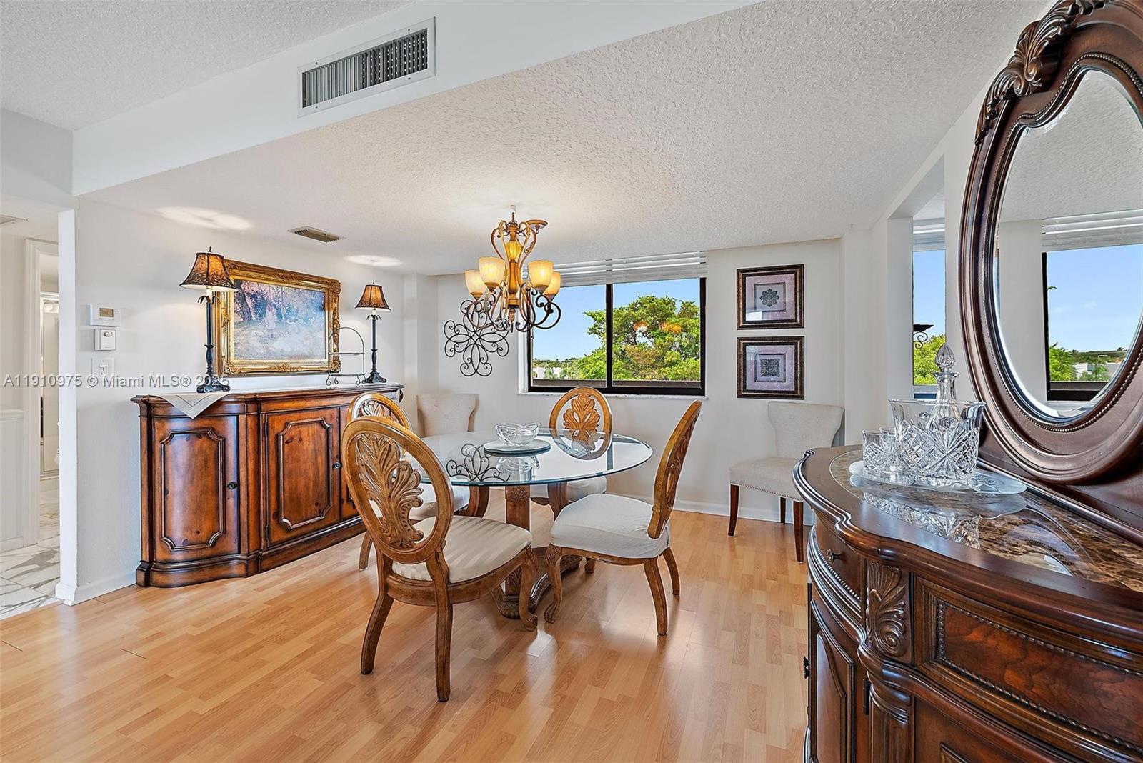 1605 Highway 1, Unit M1405 Jupiter, FL 33477 - Photo 8 of 22 a dining room with furniture and a mirror