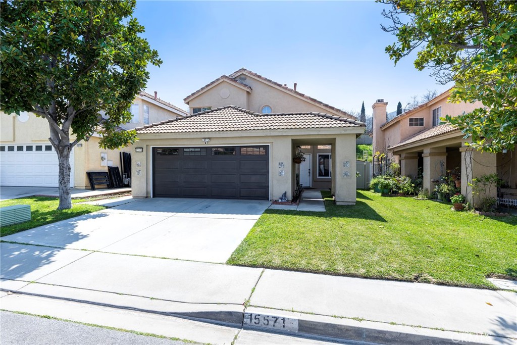 15571 Castellion Road Fontana, CA 92337 - Photo 1 of 1 front view of a house with a yard