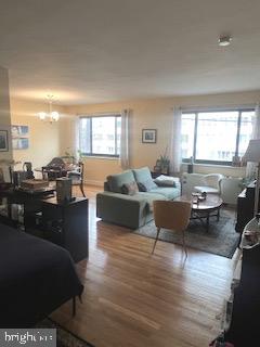 a living room with furniture window and wooden floor