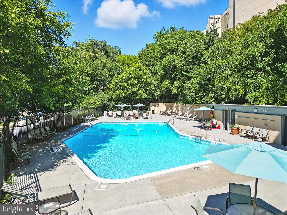1200 South Arlington Ridge Road, Unit 415 Arlington, VA 22202 - Photo 13 of 16 a swimming pool with outdoor seating and trees