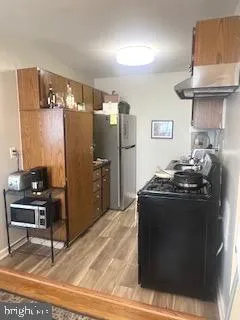 a kitchen with stainless steel appliances granite countertop a stove and a refrigerator