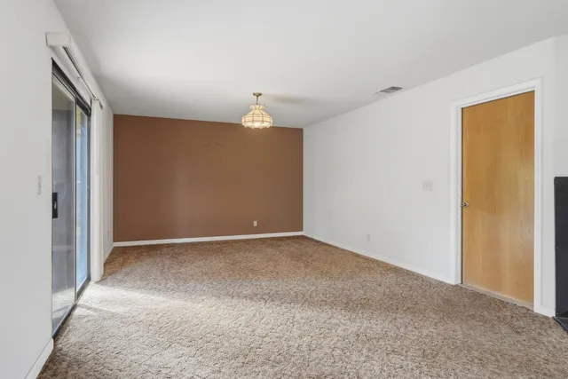 a view of empty room with a fireplace