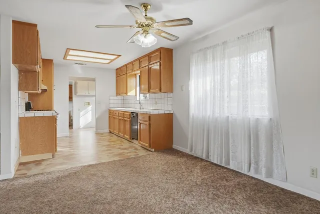 a kitchen with stainless steel appliances granite countertop a refrigerator a stove and a sink