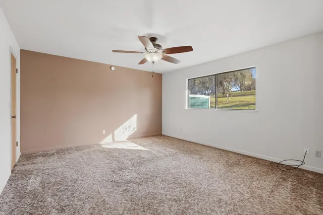 a spacious bathroom with a shower a sink and a mirror