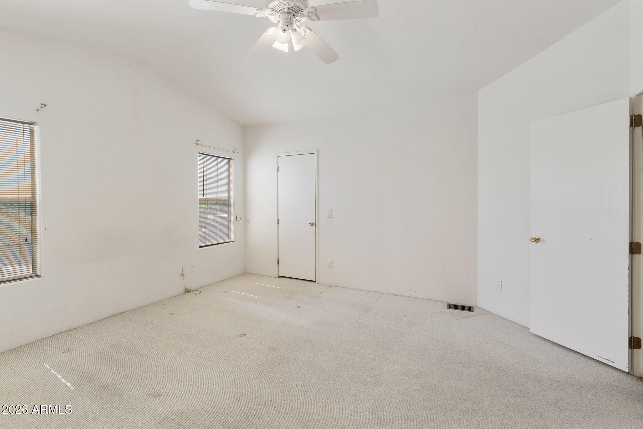 3700 South Tomahawk Road, Unit 73 Apache Junction, AZ 85119 - Photo 32 of 49 an empty room with a chandelier fan