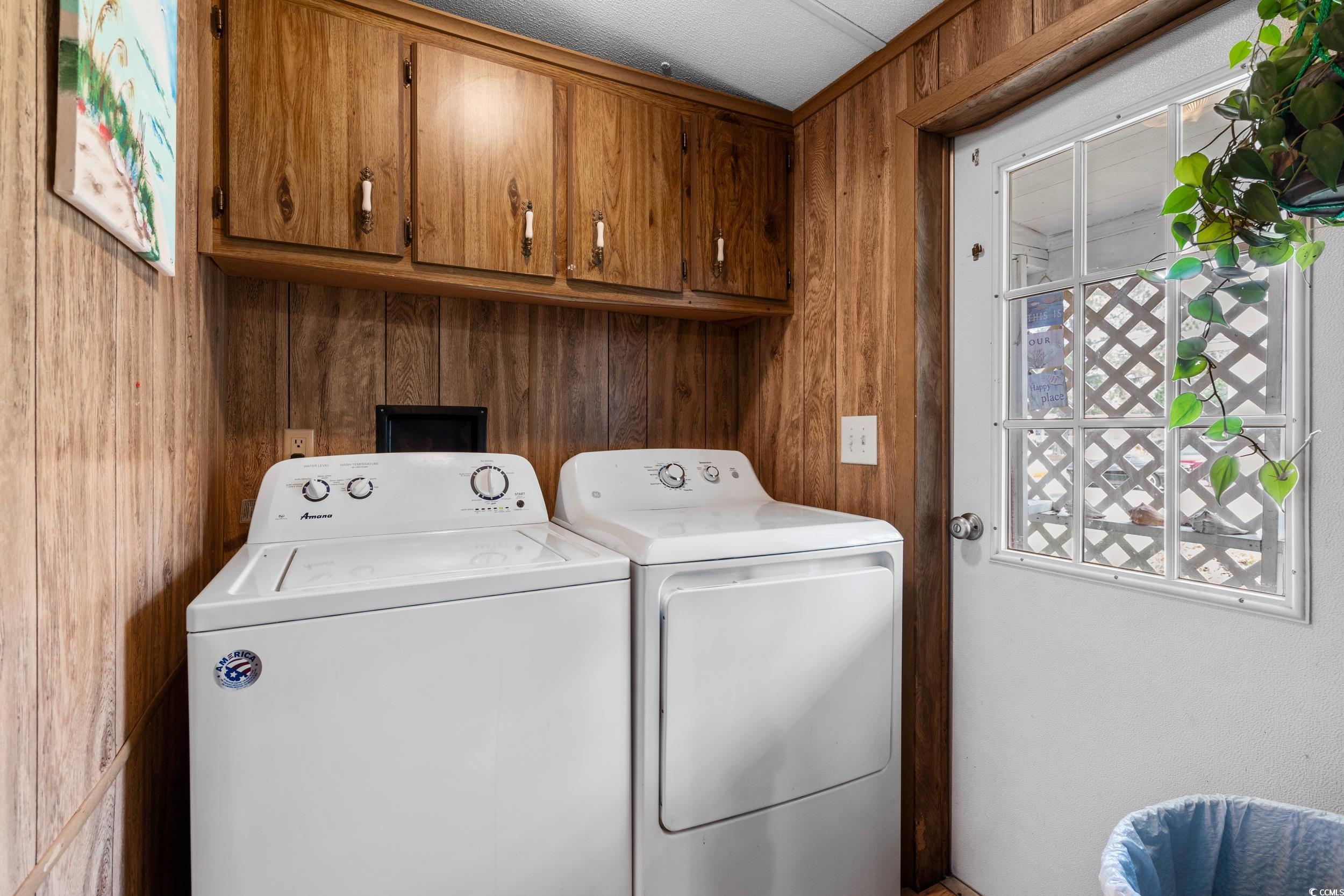 17 Crooked Island Circle Murrells Inlet, SC 29576 - Photo 14 of 39 Laundry room featuring separate washer and dryer, cabinet space, and wood walls