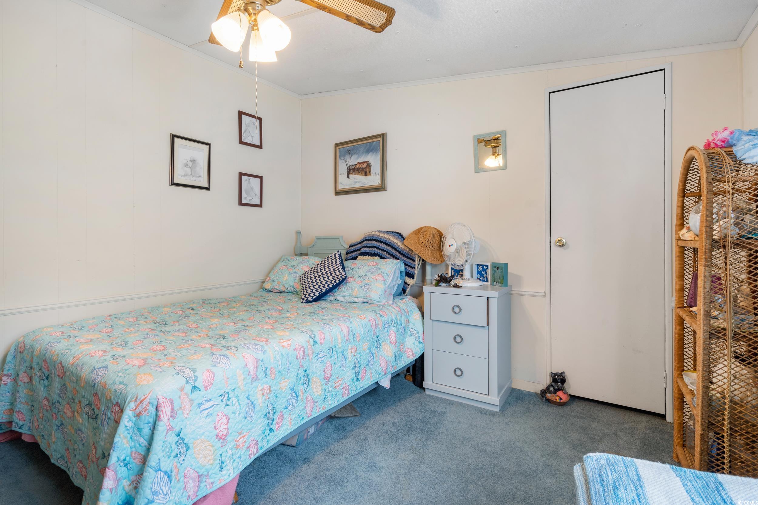 17 Crooked Island Circle Murrells Inlet, SC 29576 - Photo 24 of 39 Bedroom with carpet flooring, crown molding, and a ceiling fan