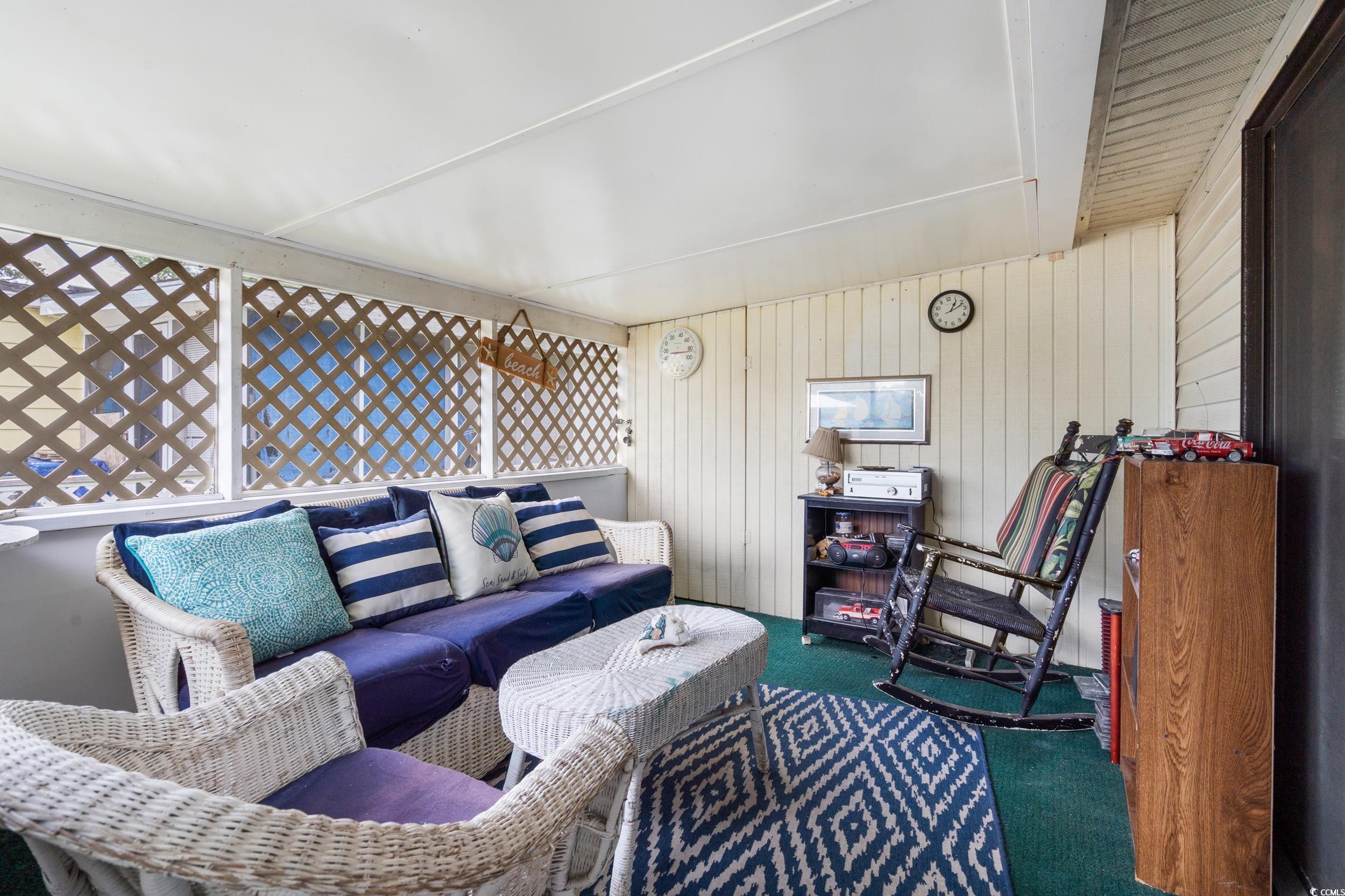 17 Crooked Island Circle Murrells Inlet, SC 29576 - Photo 27 of 39 Carpeted living room featuring wood walls