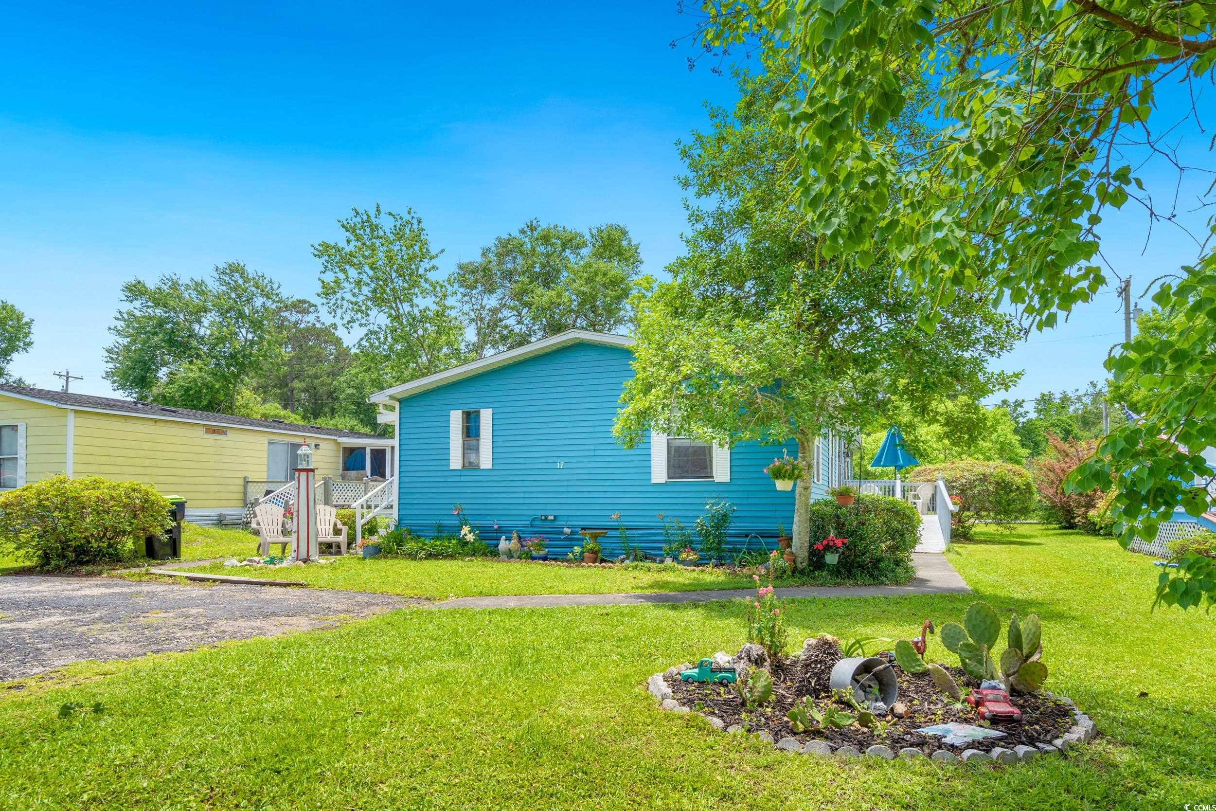 17 Crooked Island Circle Murrells Inlet, SC 29576 - Photo 32 of 39 View of property exterior featuring a lawn