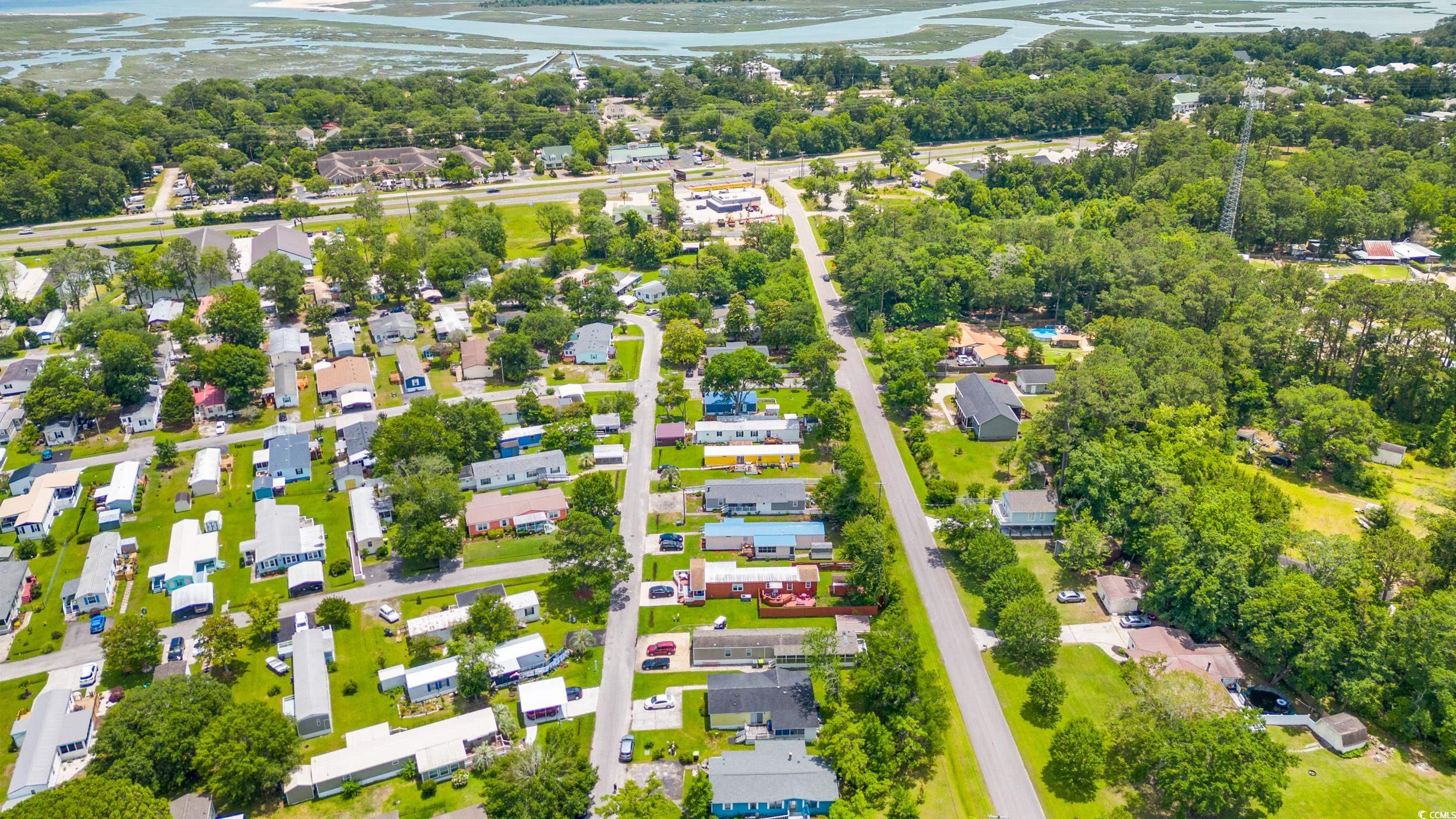 17 Crooked Island Circle Murrells Inlet, SC 29576 - Photo 38 of 39 Aerial overview of property's location with a nearby body of water, a tree filled landscape, and nearby suburban area