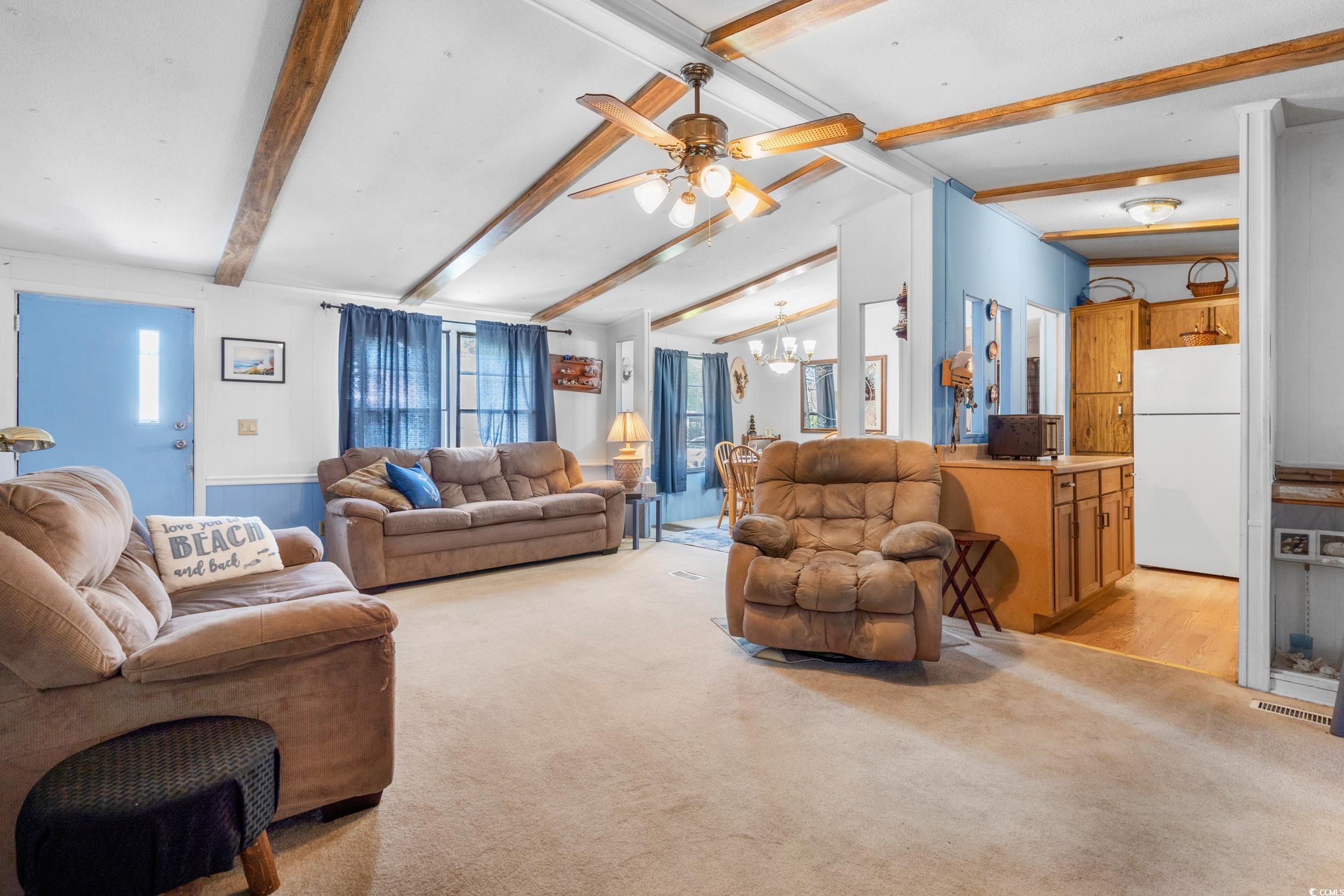 17 Crooked Island Circle Murrells Inlet, SC 29576 - Photo 5 of 39 Living area featuring a chandelier, light carpet, and ceiling fan