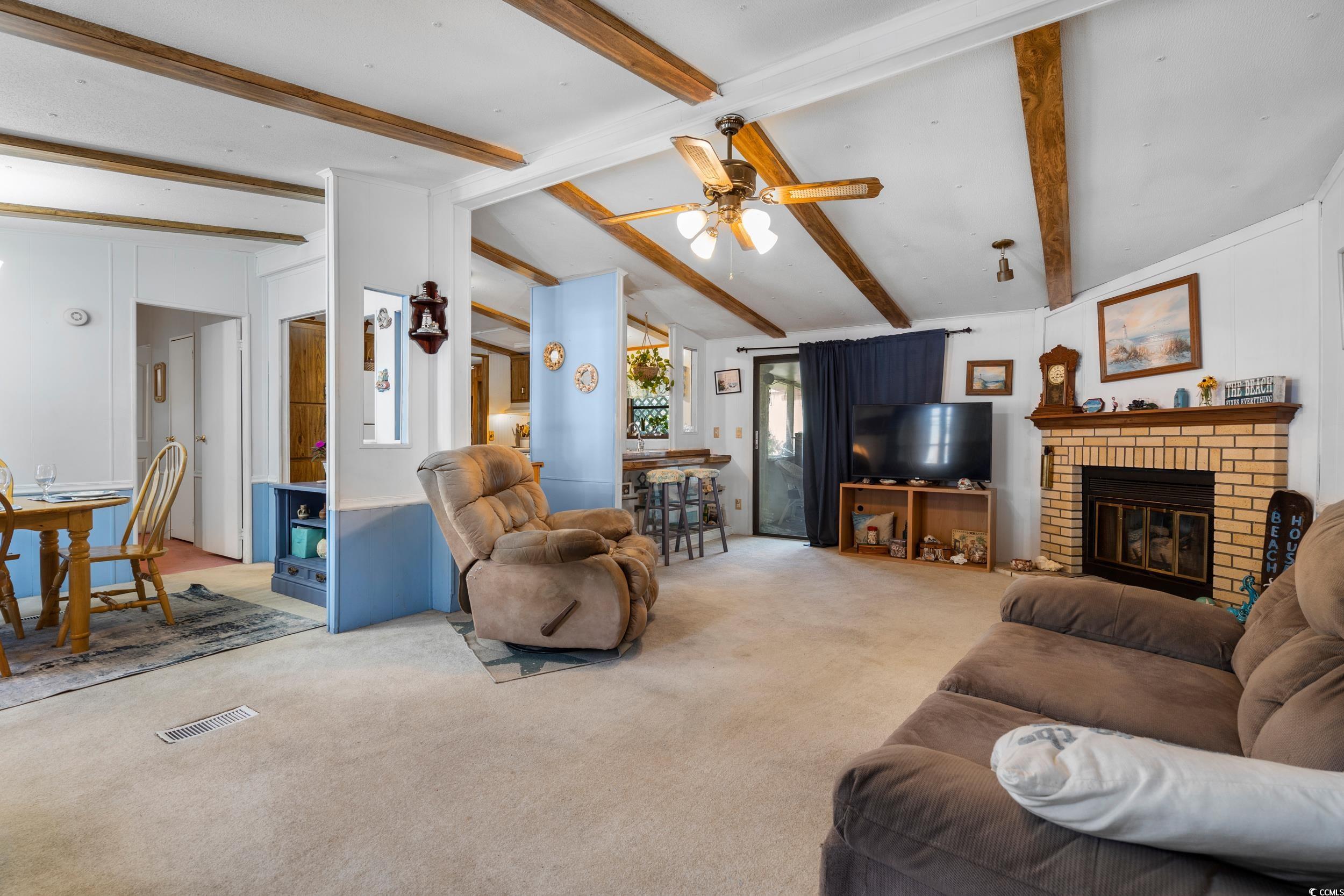 17 Crooked Island Circle Murrells Inlet, SC 29576 - Photo 6 of 39 Living room with carpet, ceiling fan, and a fireplace